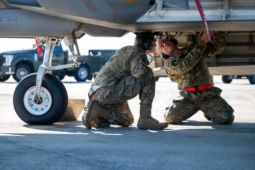Airmen load a missile onto an aircraft