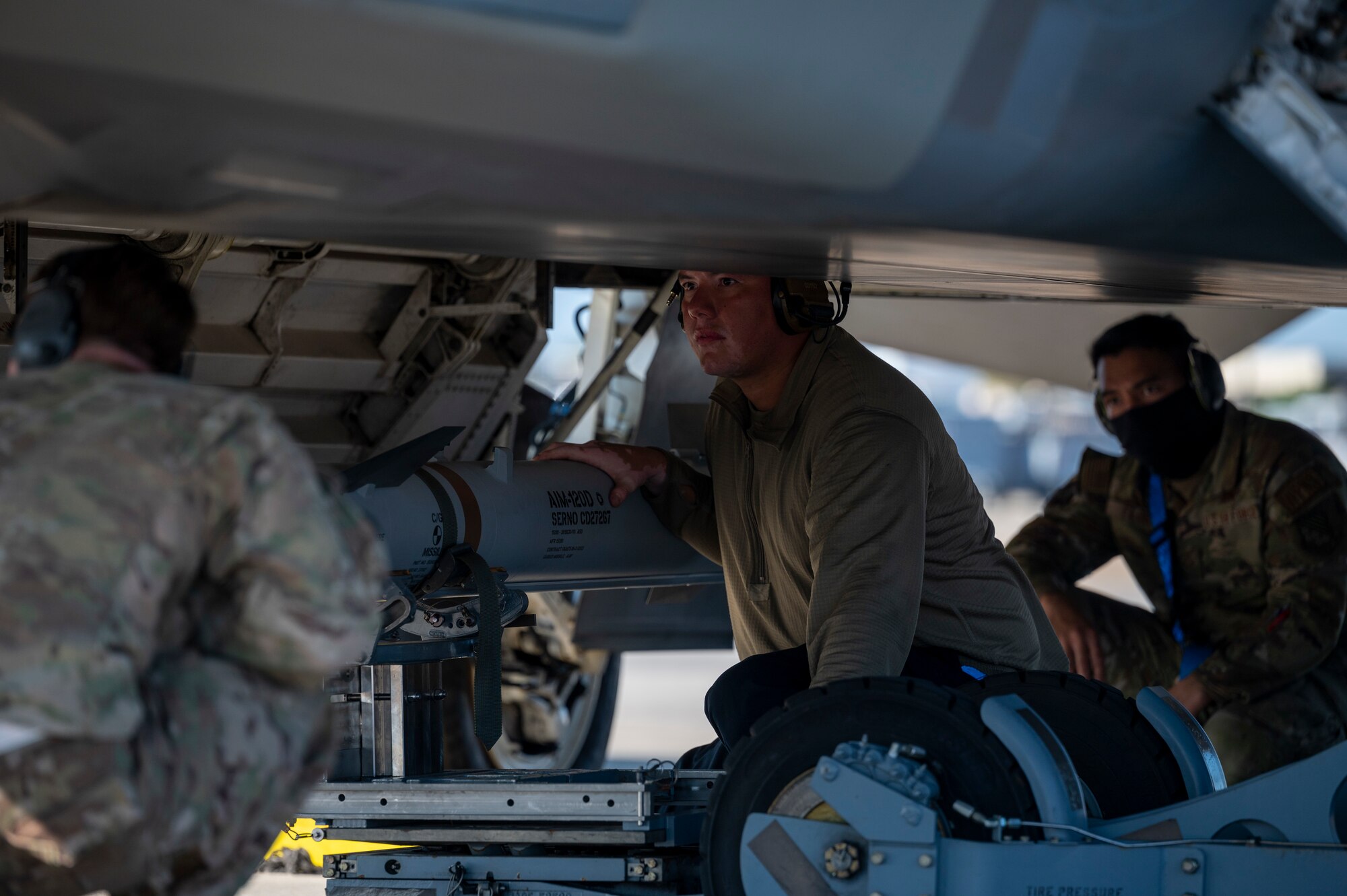 Airmen load a missile onto an aircraft