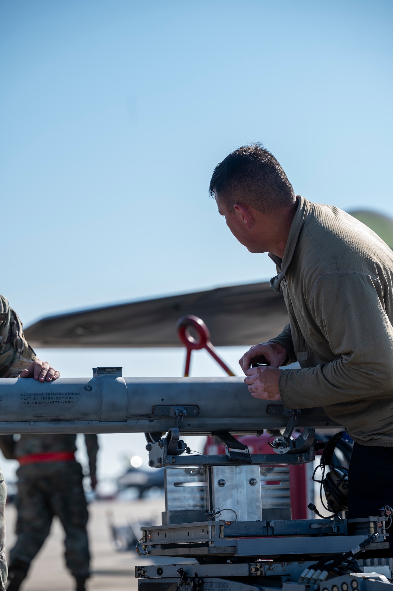 Airman secures a missile to a cart