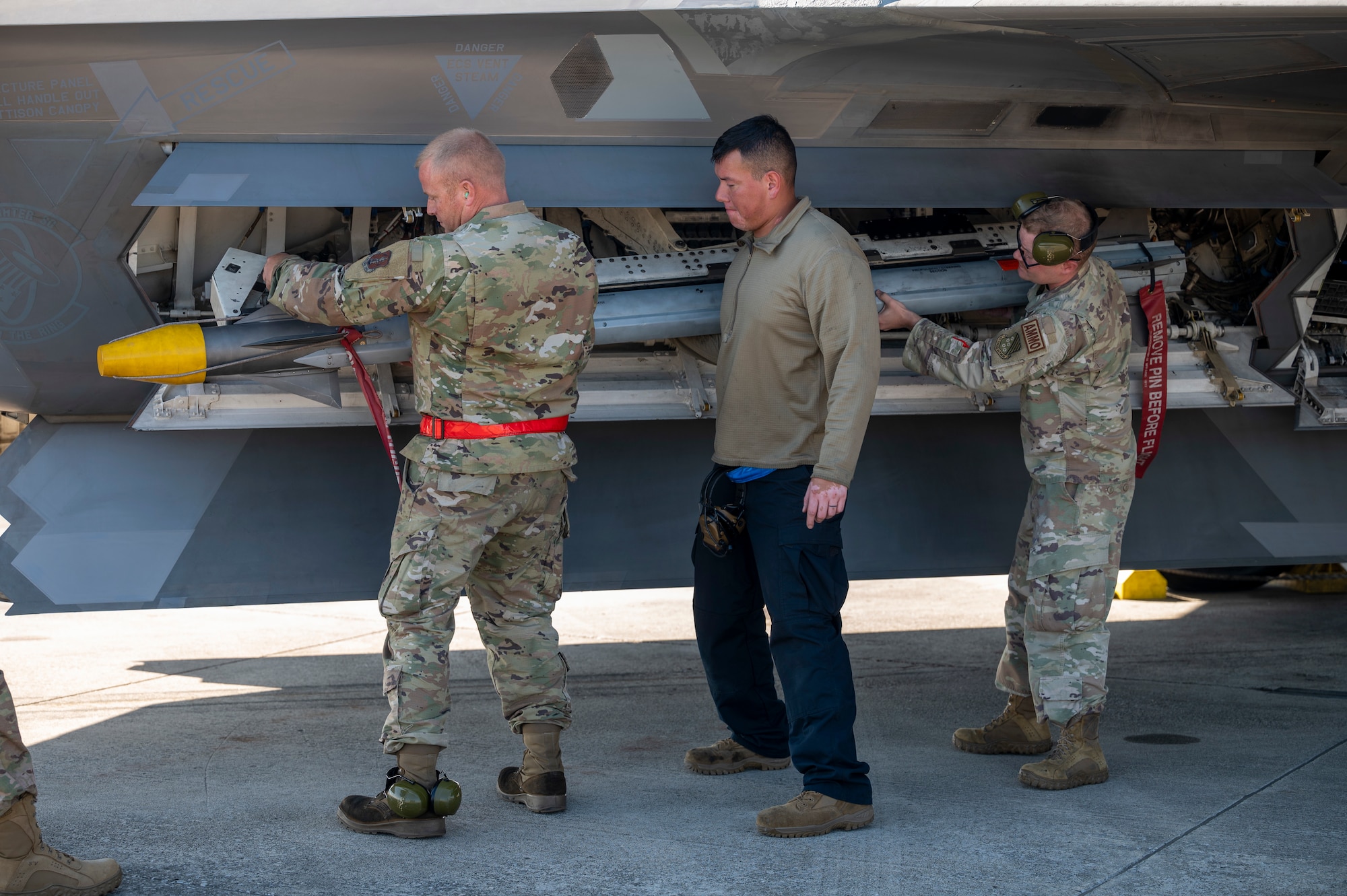 Airmen unload a missile from an aircraft