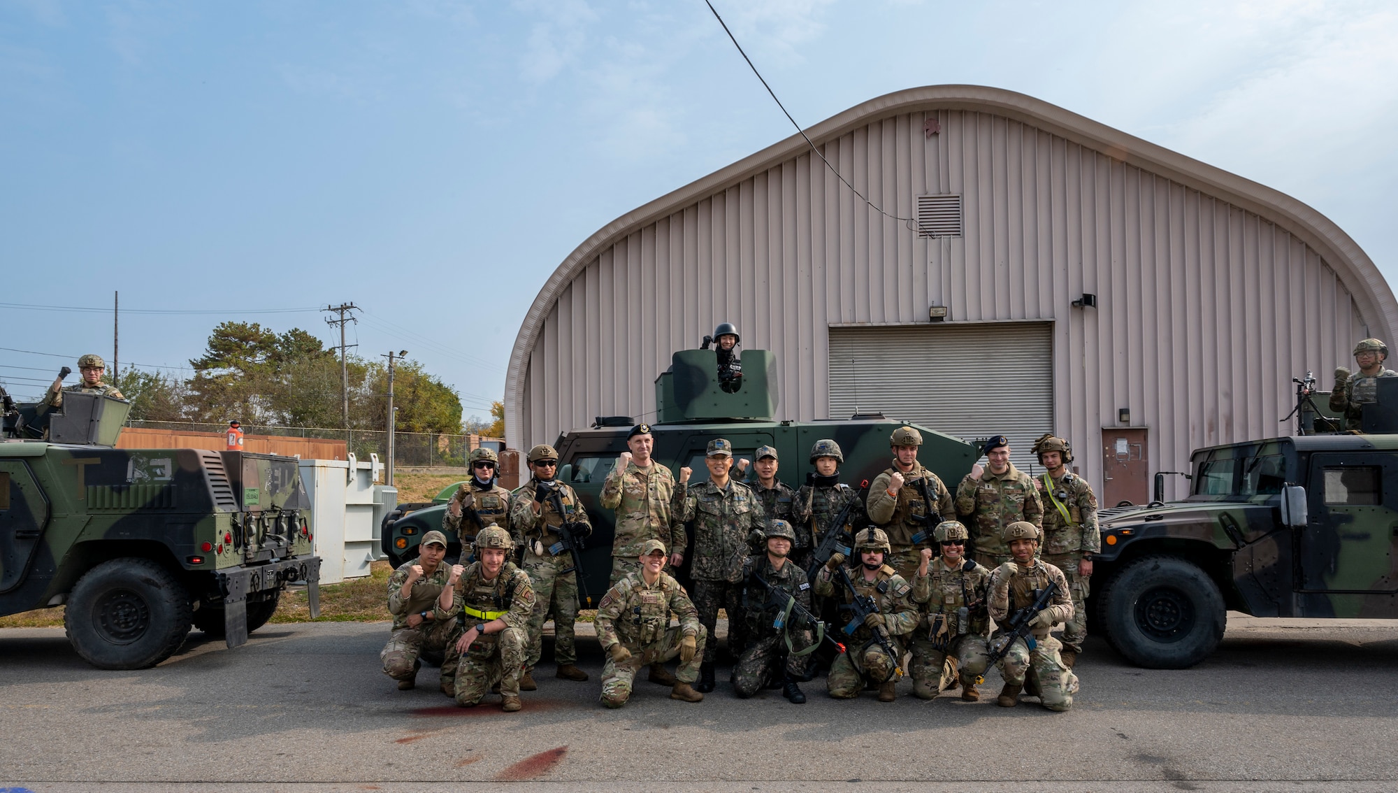 U.S. Air Force Lt. Col. Nicholas Brence, 51st Security Forces Squadron commander, center-left, and Lt. Col. Hong, Chang Hyun, Republic of Korea Military Police commander, center-right, pose for a photo with 51st SFS Defenders and ROK MPs after their joint Combat Readiness Course at Osan Air Base, ROK, Nov. 3, 2022.