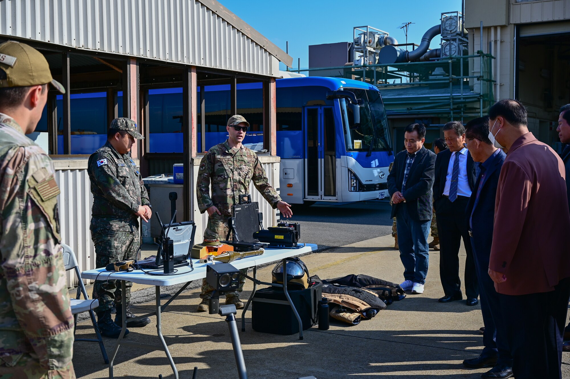 Republic of Korea Air Force Staff Sgt. Hyo Sung Jeon (left), 38th Fighter Group translator and maintainer, and U.S. Air Force Senior Airman Joseph Plato, 8th Civil Engineer Squadron explosive ordnance disposal technician, brief several religious leaders on EOD operations during the inaugural Clergy Day at Kunsan Air Base, Republic of Korea, Nov. 8, 2022. The clerical group received a tour to learn about the various ways Kunsan’s U.S. and ROKAF service members support a free and open Indo-Pacific region. (U.S. Air Force photo by Staff Sgt. Sadie Colbert)