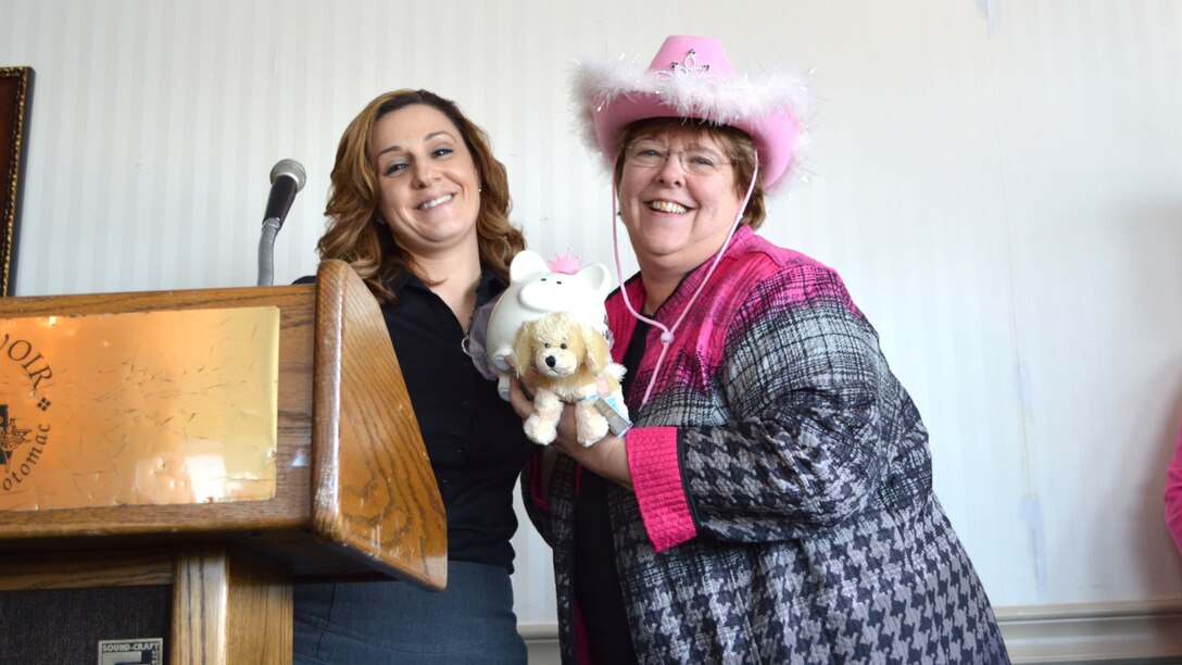 two women stand near a podium