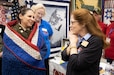 Col. Tina L. Kirkpatrick (left), commander, commander, 475th Quartermaster Group, expresses her gratitude to Donna Swanson (right), New Hampshire state coordinator, Quilts of Valor, during the International Quilting Festival in Houston Nov. 3, 2022. Swanson, whose husband, sons and grandsons are combat veterans, invited Kirkpatrick to the festival so she and her staff could present a custom quilt designed by Leo McClure, one of more than 10,000 Quilts of Valor members. Since 2003, the Quilts of Valor Foundation has covered veterans and service members touched by war with handmade quilts made by one of more than 10,000 Foundation members spread throughout the country. The Foundation achieved a major milestone when it produced its 300,000th quilt in April 2022. (U.S. Army photo by Staff Sgt. John L. Carkeet IV, 75th Innovation Command)