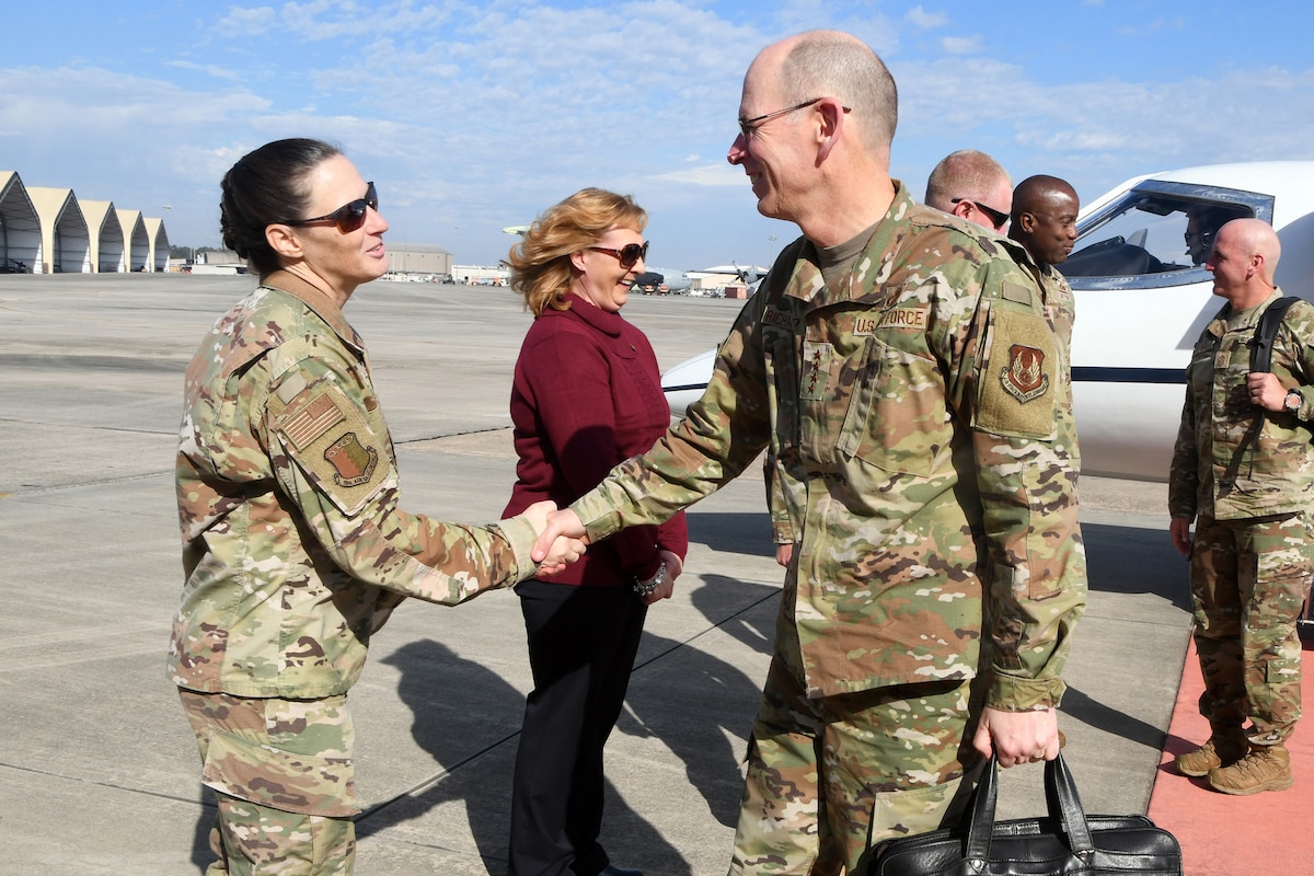 Photo shows two people shaking hands