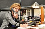 Linda Barnett sitting at a desk on the phone
