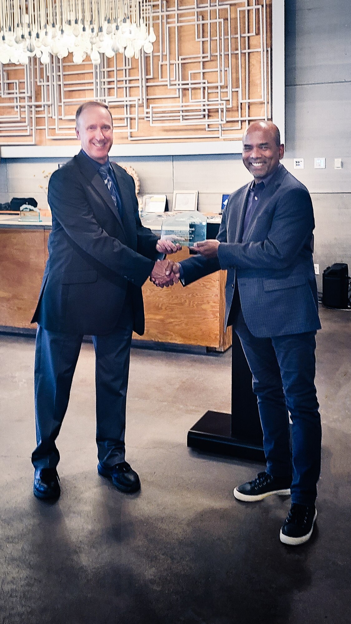 Quentin Dierks, Air Force Research Laboratory, or AFRL, Space Vehicles Directorate chief engineer, presents Dr. Wellesley Pereira, Space Vehicles Directorate senior scientist and mission lead, with a 2022 Innovation Award for Excellence in Technology Transfer at AFRL’s Innovation Awards ceremony in Albuquerque, New Mexico, Oct. 20, 2022. AFRL established these awards to recognize and inspire the laboratory’s inventors and collaborators who develop technologies in support of the nation’s defense and whose research promotes the transfer of technology to partners, academia and the private sector. (U.S. Air Force photo/Jeanne Dailey)