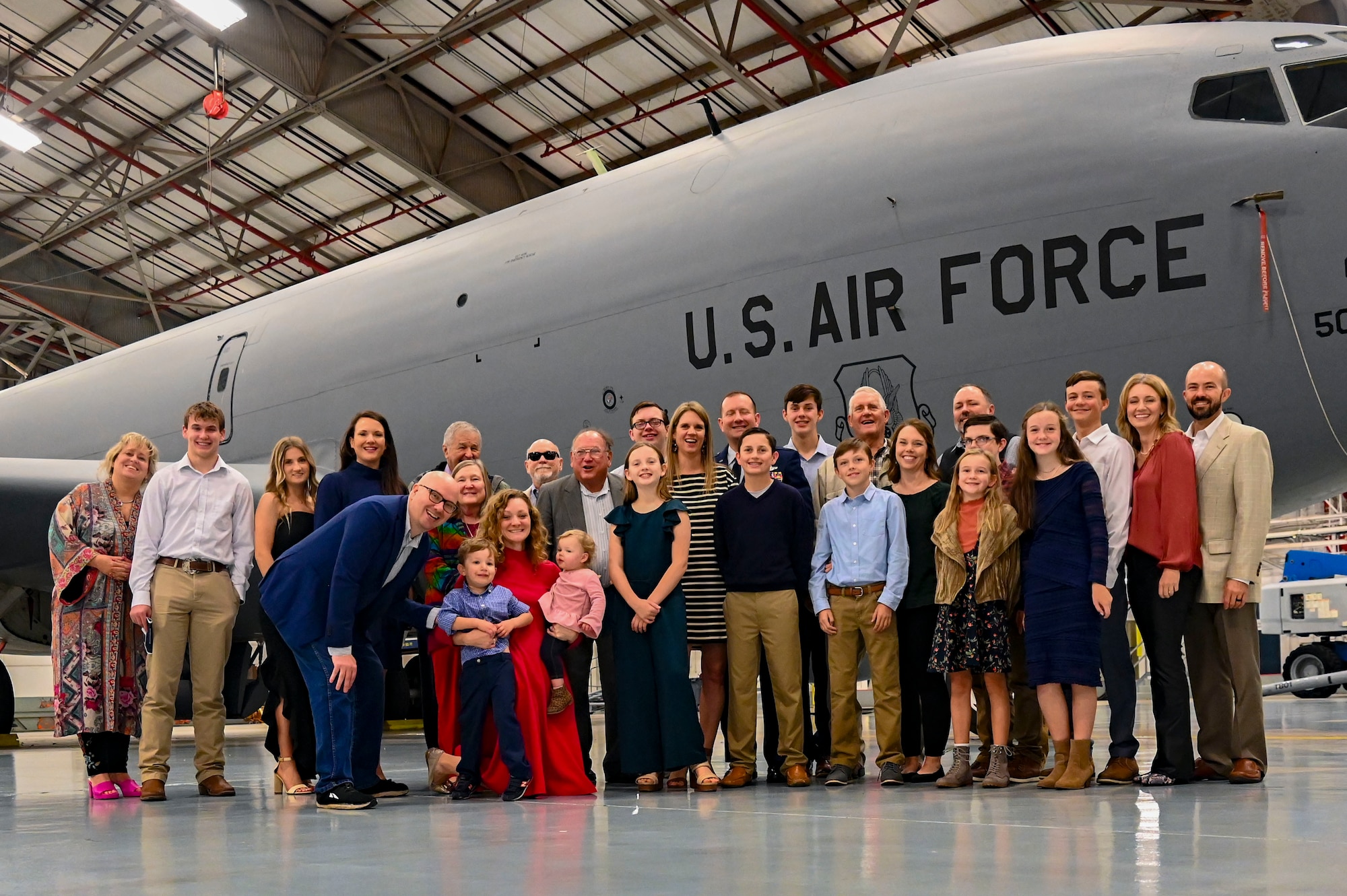 a group of people in front of a jet