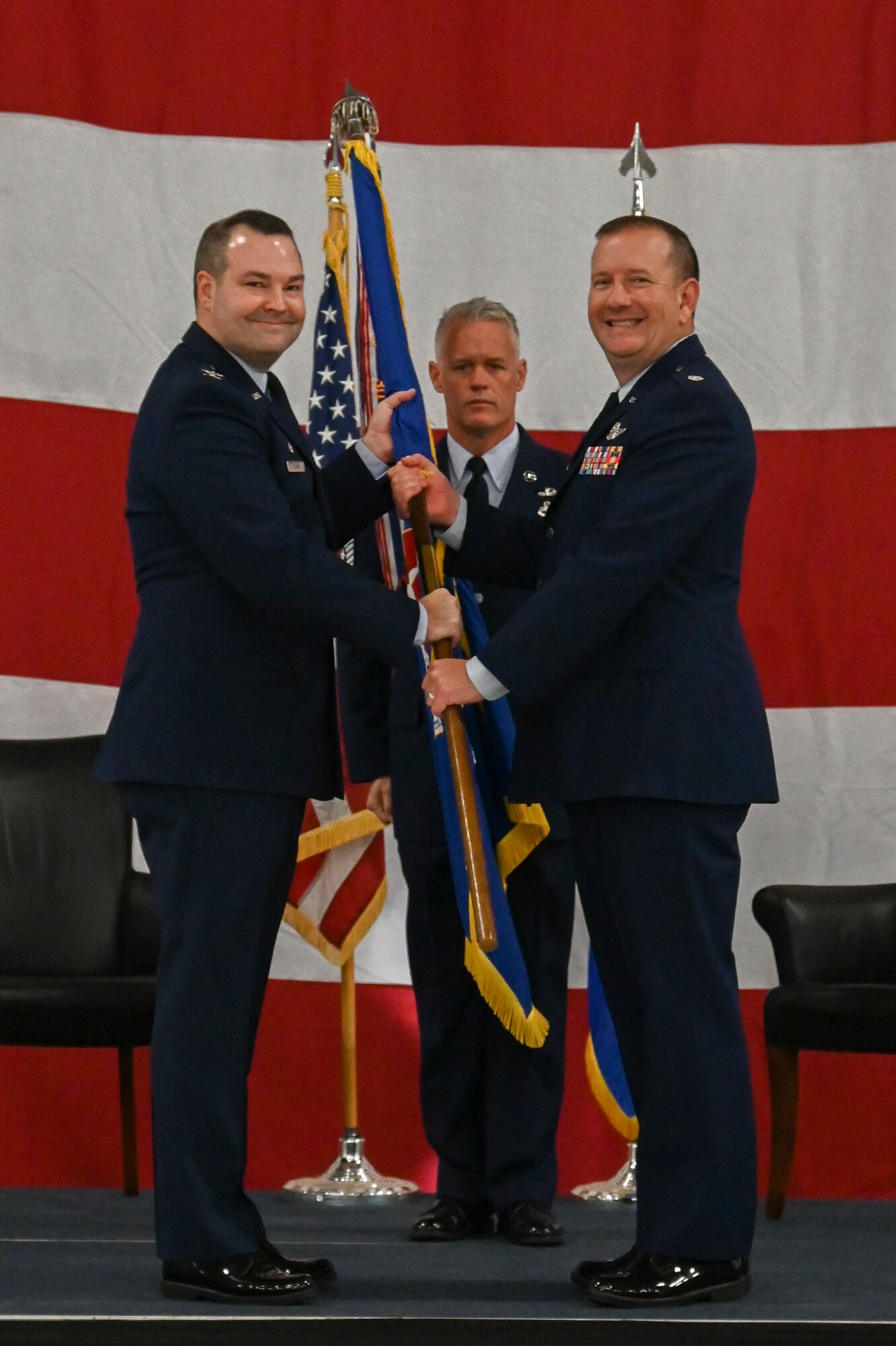 men holding a flag and smiling