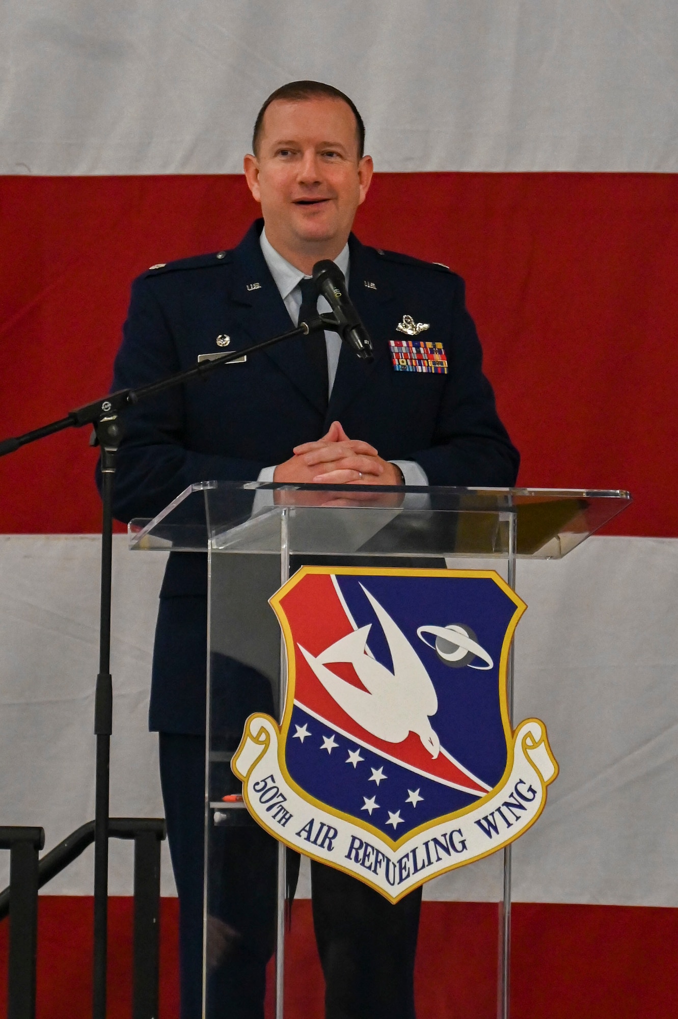 man standing at podium, speaking