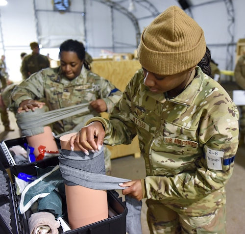 Staff Sgt. Aniah Nettles wraps a wound with pressure as part of the 88th Air Base Wing readiness exercise, Wright-Patterson Air Force Base, Nov. 3, 2022. The Wing assessment evaluated basic Airman readiness skills to include Chemical, Biological, Radiation and Nuclear (CBRN) survival training, Tactical Combat Casualty Care (TCCC) training and M4 carbine weapons handling. (U.S. Air Force photo by Matthew Clouse)