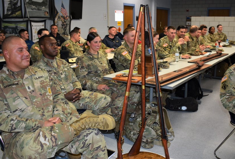 soldiers seated at tables with trophies