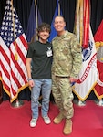 Jordan Page (left) and father, U.S. Air Force Chief Master Sgt. Michael Page, Eastern Sector senior enlisted advisor (right), pose for a photo following Jordan's oath of enlistment at Milwaukee MEPS. Jordan joins the Air Force Delayed Entry Program as he prepares to leave for basic training July 2023.