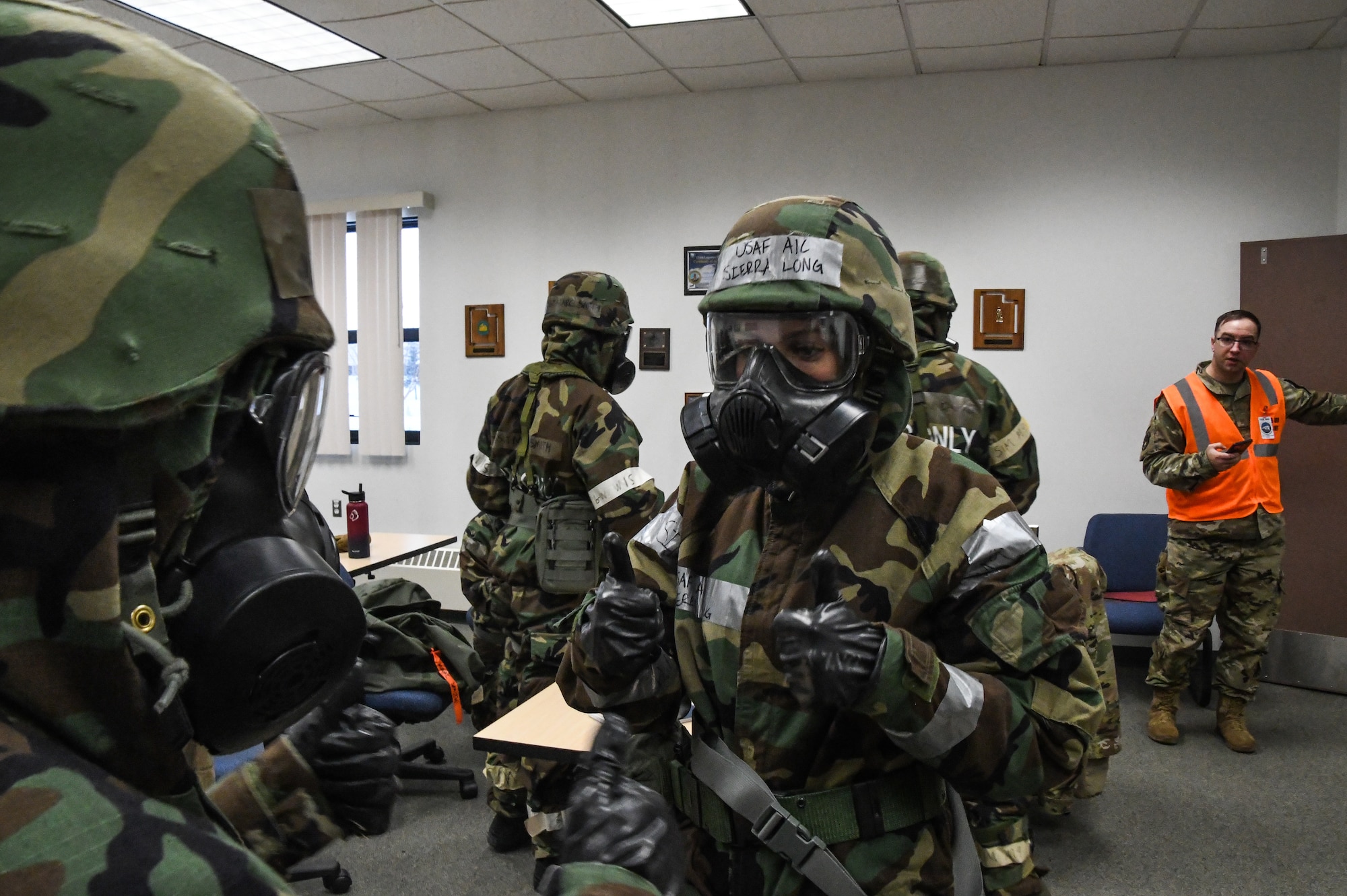 Members of the 168th Wing dress out in Mission-Oriented Protective Posture gear in a hardened shelter during exercise Golden Raven 23-1 at Eielson Air Force Base, Alaska, Nov. 4, 2022. Golden Raven 23-1 was a readiness inspection testing the capabilities to deploy Airmen effectively.  (U.S. Air National Guard photo by Senior Master Sgt. Julie Avey)