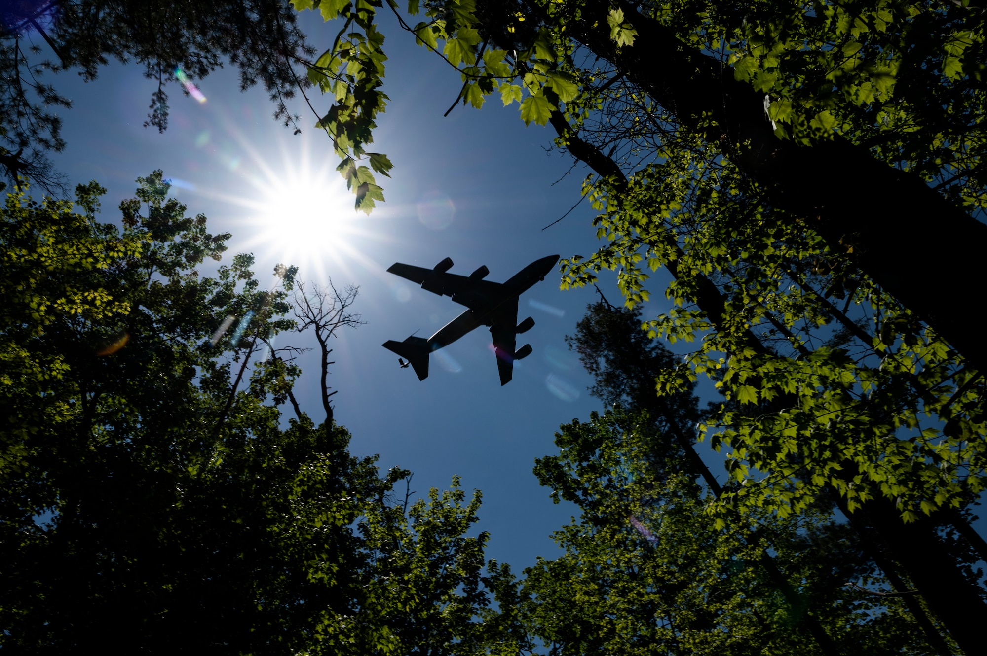 A KC-135 Stratotanker flies over a park