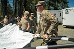 U.S. Army Sgt. Liam Seagle, 147th Brigade Support Battalion, Colorado Army National Guard helps set up a tent during an external evaluation in Camp Rilea, Oregon, July 11, 2022. Seagle is part of the Colorado National Guard’s Chemical, Biological, Radiological, Nuclear and high-yield explosive Enhanced Response Force Package. ExEval is a 24-36-month certification process that validates CERFP’s mission readiness and capability. (U.S. Army National Guard photo by Sgt. Elizabeth Clark)