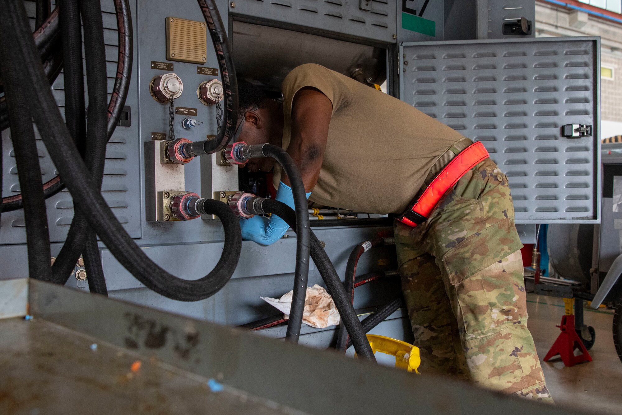 Senior Airman Nadir Jones, 31st Maintenance Squadron Aerospace Ground Equipment journeyman, works inside of a hydraulic test stand at Aviano Air Base, Italy, Oct. 24, 2022. The test stands that AGE maintain are used for cycling, testing and pressurizing various aircraft hydraulic assemblies. (U.S. Air Force photo by Airman 1st Class Thomas Calopedis)