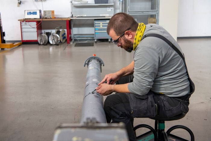 Luca del Bosco, 31st Maintenance Squadron Aerospace Ground Equipment mechanic, maintains equipment at Aviano Air Base, Italy, Oct. 24, 2022. Del Bosco is one of three Italians in the bomb lift section working side-by-side with U.S. Air Force Airmen. (U.S. Air Force photo by Airman 1st Class Thomas Calopedis)