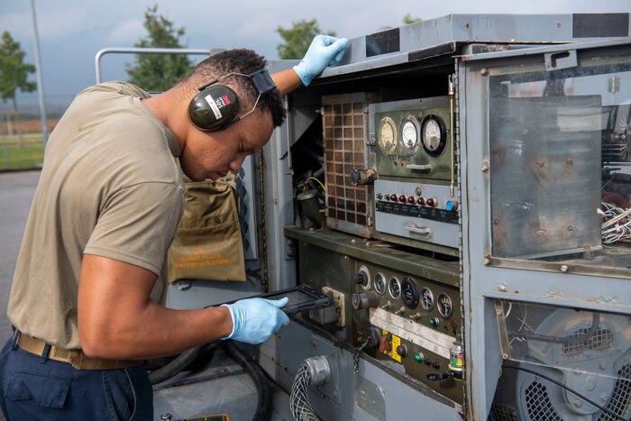 Senior Airman Danyel Pendleton, 31st Maintenance Squadron Aerospace Ground Equipment journeyman tests a generator electrical output at Aviano Air Base, Italy, Oct. 24, 2022. Pendleton reviewed technical data which provided clear and concise instructions for the maintenance and operation of Air Force equipment. (U.S. Air Force photo by Airman 1st Class Thomas Calopedis)