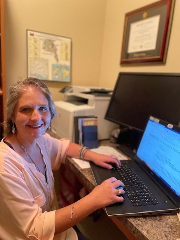 Tina Gatewood, Mobile District customer service representative, works from home on her computer Oct. 31, 2022, Mobile, Alabama. Gatewood, who has worked for the District since 2016, was diagnosed with Stage IV colon cancer in May of 2021 and has continued to handle the payroll for the District since her diagnosis. (Courtesy photo)