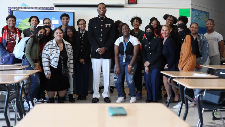 U.S. Marine Corps Capt. Richmond Jackson, an information system security manager for the Marine Corps Recruiting Command, poses with Cass Technical High School students in Detroit, Mich., Nov. 2, 2022. With no support on his education while growing up, Jackson defied all odds and created a successful career within the Marine Corps. (Marine Corps photo by Cpl. Austin Fraley)
