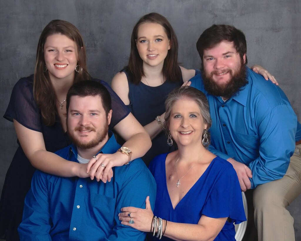 Tina Gatewood, Mobile District customer service representative, bottom right, poses with her family for a recent family portrait Oct. 8, 2022, Mobile, Alabama. Gatewood, who was diagnosed with Stage IV colon cancer in May of 2021, still ensures the payroll is met for the District’s over 1,500 employees. (Courtesy photo)