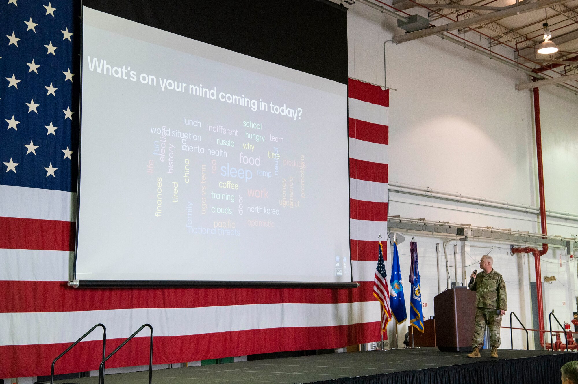 Col. Magnusson speaks while reading a presentation slide.