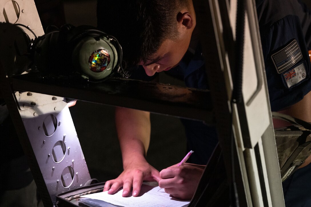 U.S. Air Force Staff Sgt. James Nichols, 28th Aircraft Maintenance Squadron dedicated crew chief assigned to Ellsworth Air Force Base, South Dakota, signs a post flight inspection after Bomber Task Force mission at Andersen AFB, Guam, Nov. 5, 2022. BTF missions provide opportunities to train and work with our allies and partners in joint and coalition operations and exercises. (U.S. Air Force photo by Staff Sgt. Hannah Malone)