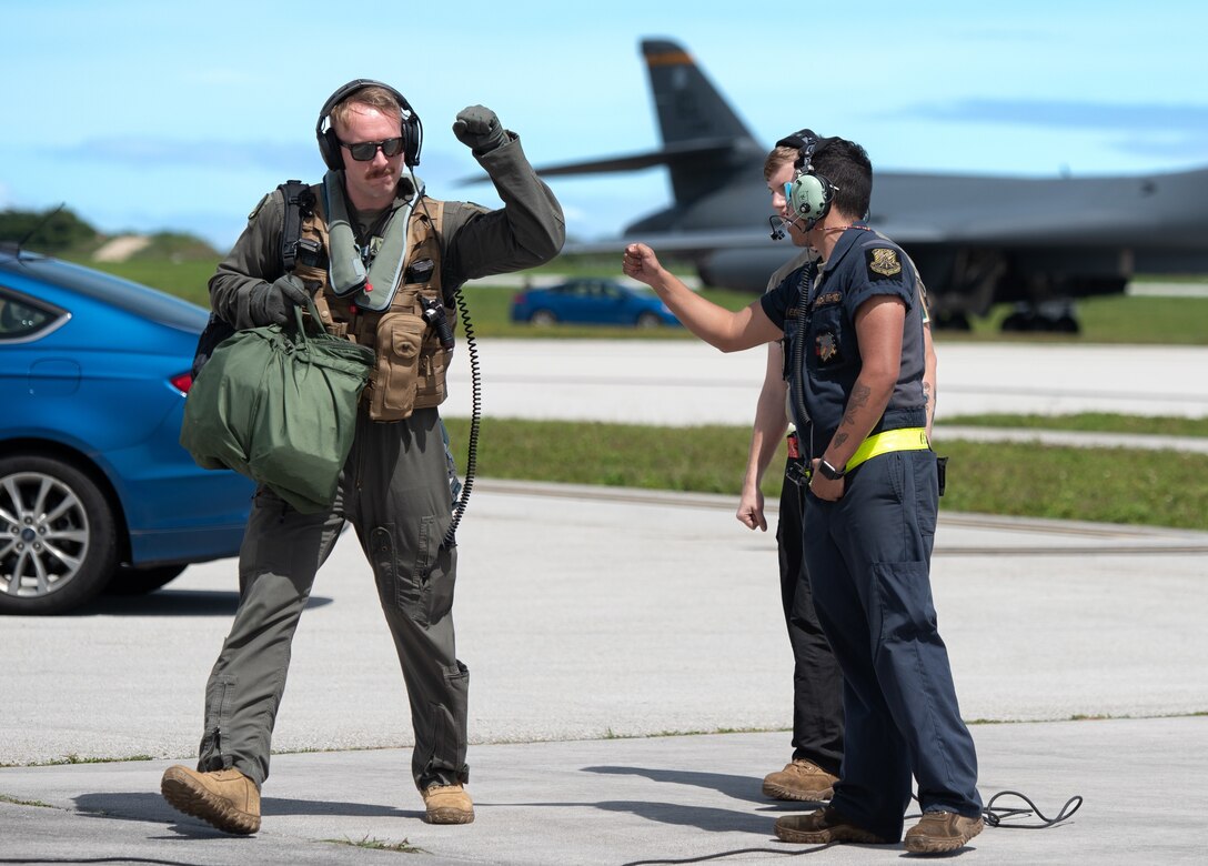 U.S. Air Force Capt. Josh Kirk, 37th Expeditionary Bomb Squadron weapons system operator, left, greets Senior Airman Hector Estrada, 28th Aircraft Maintenance Squadron crew chief, both assigned to Ellsworth Air Force Base, South Dakota, prior to boarding a B-1B Lancer at Andersen AFB, Guam, Nov. 2, 2022. The United States is dedicated to maintaining a region comprised of nations that adhere to the international rule of law. (U.S. Air Force photo by Senior Airman Yosselin Campos)