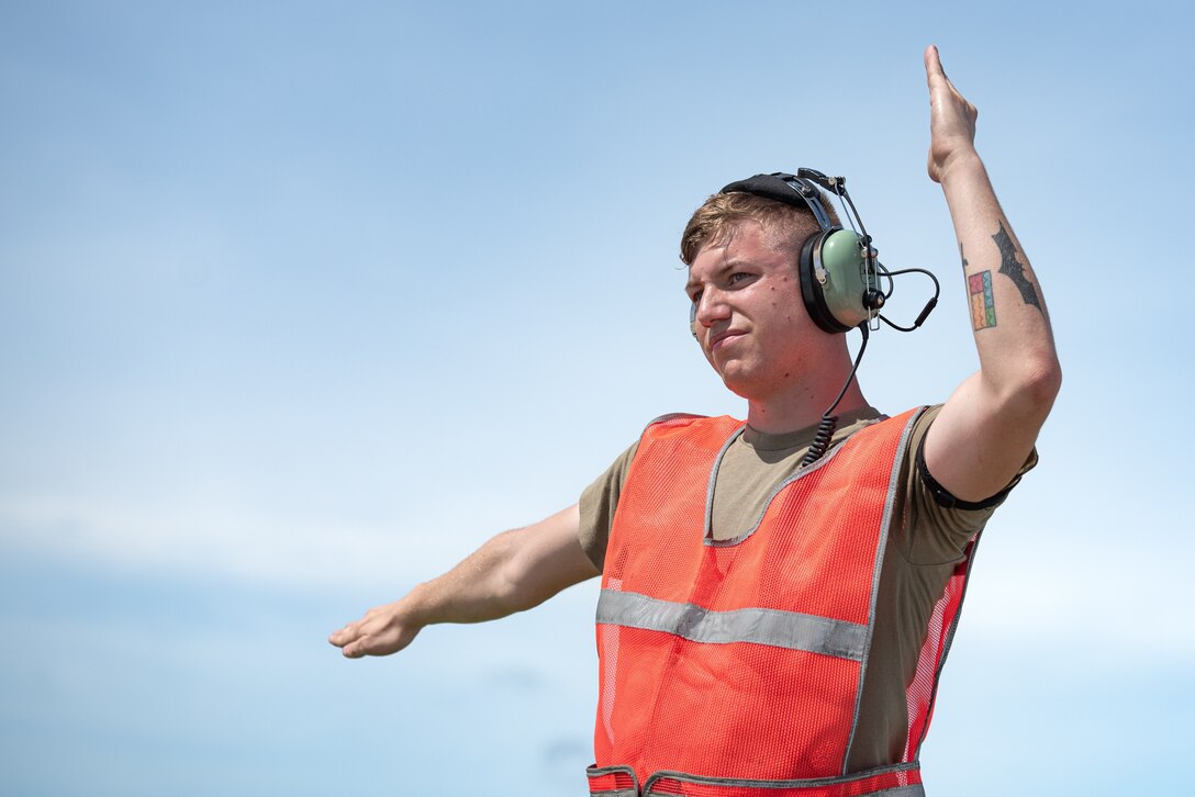 U.S. Air Force Staff Sgt. Jacob Hurst, 28th Aircraft Maintenance Squadron crew chief assigned to Ellsworth Air Force Base, South Dakota, marshals a B-1B Lancer in support of a Bomber Task Force mission at Andersen AFB, Guam, Nov. 5, 2022. The U.S. Indo-Pacific Command’s force employment, military posture, and operations honor security commitments in the region by enabling the USAF to rapidly respond to any potential crisis or challenge in the Indo-Pacific. (U.S. Air Force photo by Senior Airman Yosselin Campos)