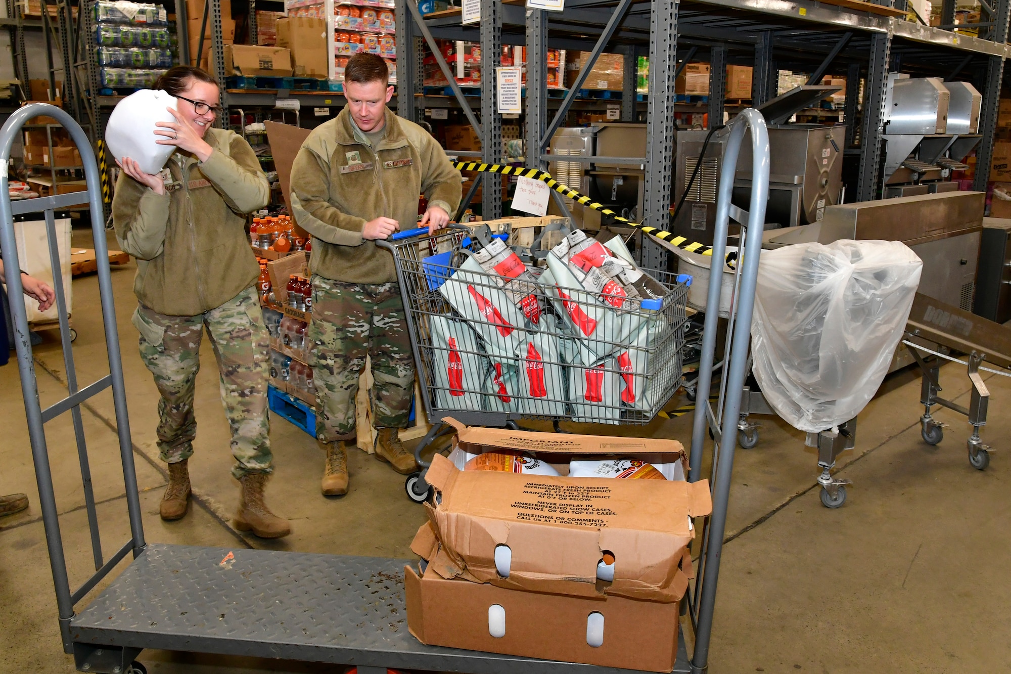 (Left to right) Technical Sgt. Beth Burch, 388th Munitions Squadron, and Master Sgt. David Sifers, 388th Munitions Squadron, sort Thanksgiving turkeys and meal bags at the base Commissary for Operation Warm Heart Nov. 8, 2022, at Hill Air Force Base, Utah. The annual program is accomplished by Hill’s first sergeant’s organization, who work closely with the Hill Commissary to plan, organize and distribute all the fixings for a tasty Thanksgiving meal for military families. (U.S. Air Force photo by Todd Cromar)