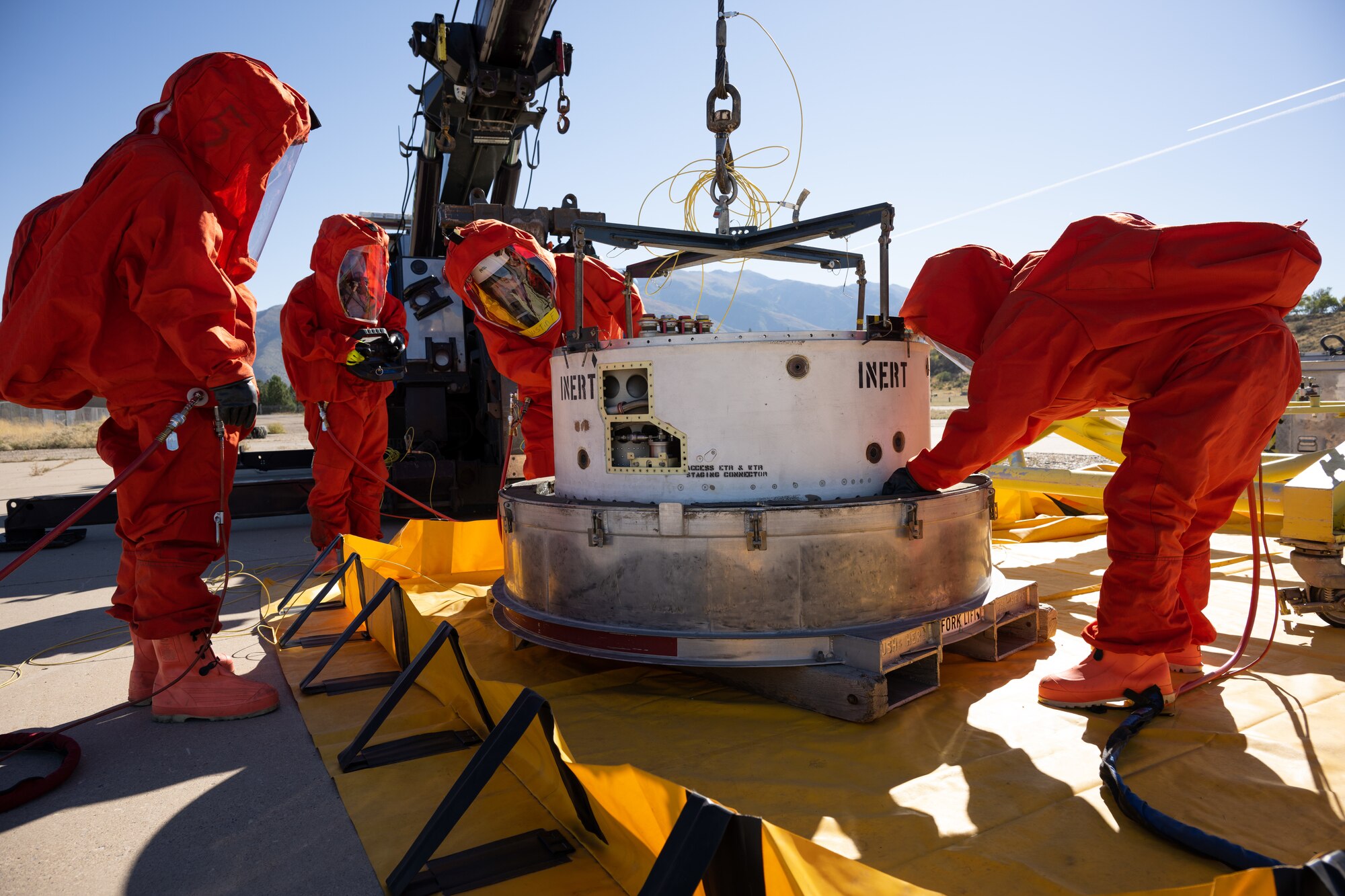 Members of the Missile Mishap Response Team place a Minuteman III inert guidance system  into a container during a training event at Hill Air Force Base, Utah, Oct. 2, 2022.