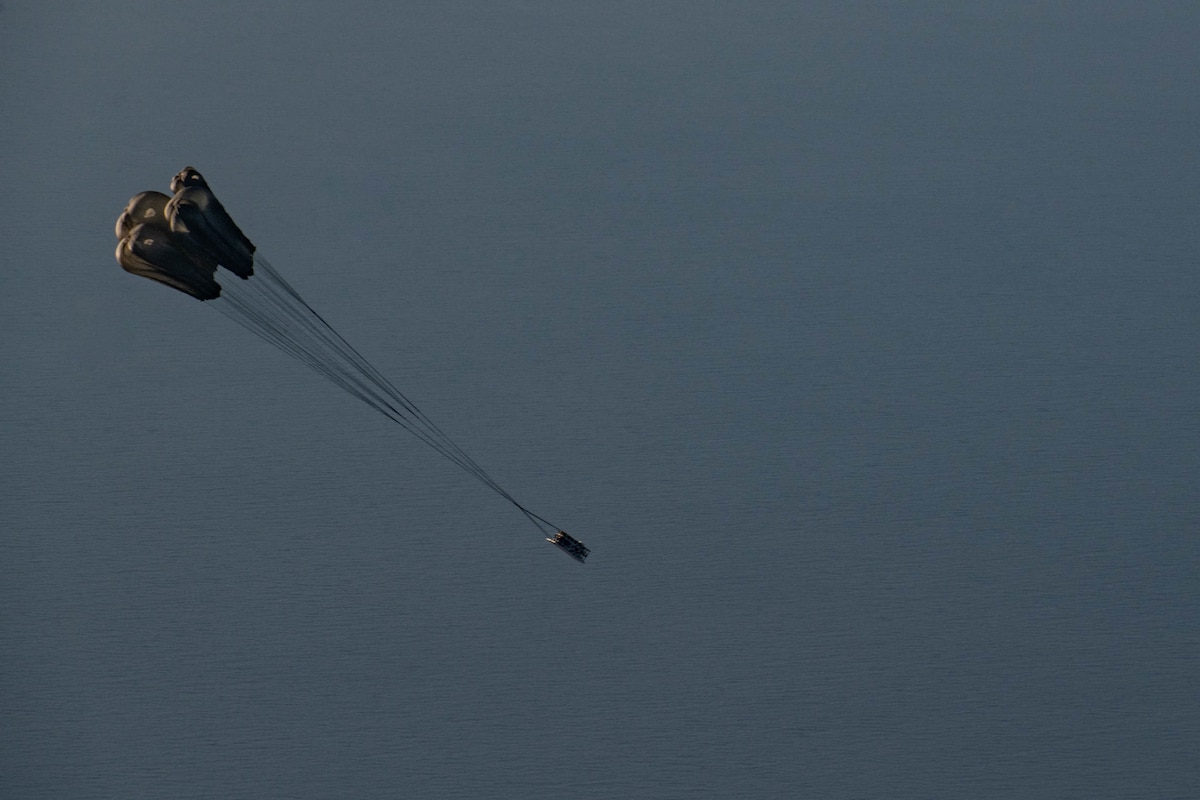 A palletized effects system falls from the cargo hold of a 352d Special Operations Wing MC-130J Commando II during a live-fire demonstration for ATREUS 22-4 at Andøya Space Defense Range, Norway, Nov. 9, 2022. This is the first time Rapid Dragon, a precision effects capability for medium-sized or larger cargo aircraft that allows U.S. and NATO forces a flexible rapid response option, has been employed in the U.S. European Command theater. (U.S. Air National Guard photo by Tech. Sgt. Brigette Waltermire)