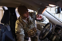 Sgt. Keyvin Pacheco, a military policeman with Company A, 49th Missile Defense Battalion searches a vehicle at the entry control facility to the missile defense complex during exercise Guardian Watch 23 at Fort Greely, Alaska, Nov. 1, 2022. Guardian Watch 23 focused on conducting ground-based midcourse defense and critical installations security, which are the two missions of the 49th Missile Defense Battalion. (Alaska National Guard photo by Staff Sgt. Katie Mazos-Vega)