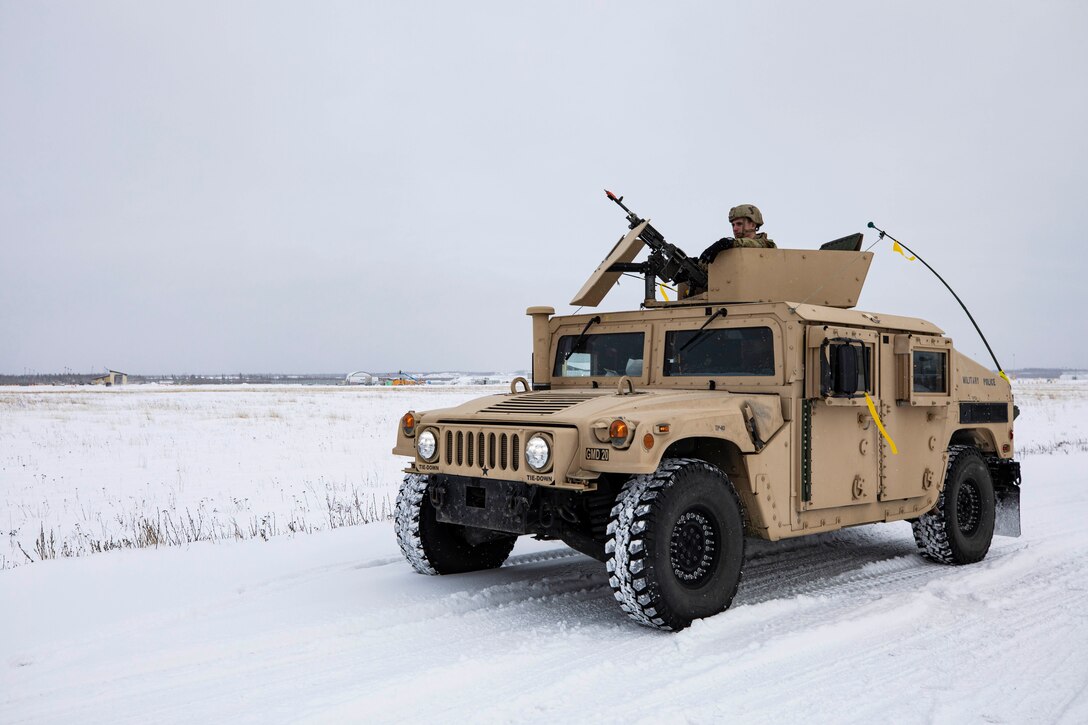 Spc. Christopher Mosen, a military policeman with 113th Military Police Company, Mississippi Army National Guard pulls security on a patrol around the missile defense complex during Exercise Guardian Watch 23 at Fort Greely, Alaska, Oct. 31, 2022. Guardian Watch 23 focused on conducting ground-based midcourse defense and critical installations security, which are the two missions of the 49th Missile Defense Battalion. (Alaska National Guard photo by Staff Sgt. Katie Mazos-Vega)