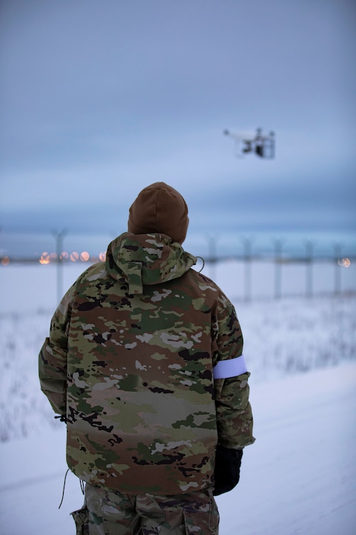 Chief Warrant Officer 2 John Sorrells, an unmanned aerial systems operator with 100th Missile Defense Brigade, Colorado Army National Guard, tests his unmanned aerial vehicle before sending it over the fence for a simulated UAS attack on the missile defense complex during exercise Guardian Watch 23 at Fort Greely, Alaska, Nov. 1, 2022. Guardian Watch 23 focused on conducting ground-based midcourse defense and critical installations security, which are the two missions of the 49th Missile Defense Battalion. (Alaska National Guard photo by Staff Sgt. Katie Mazos-Vega)