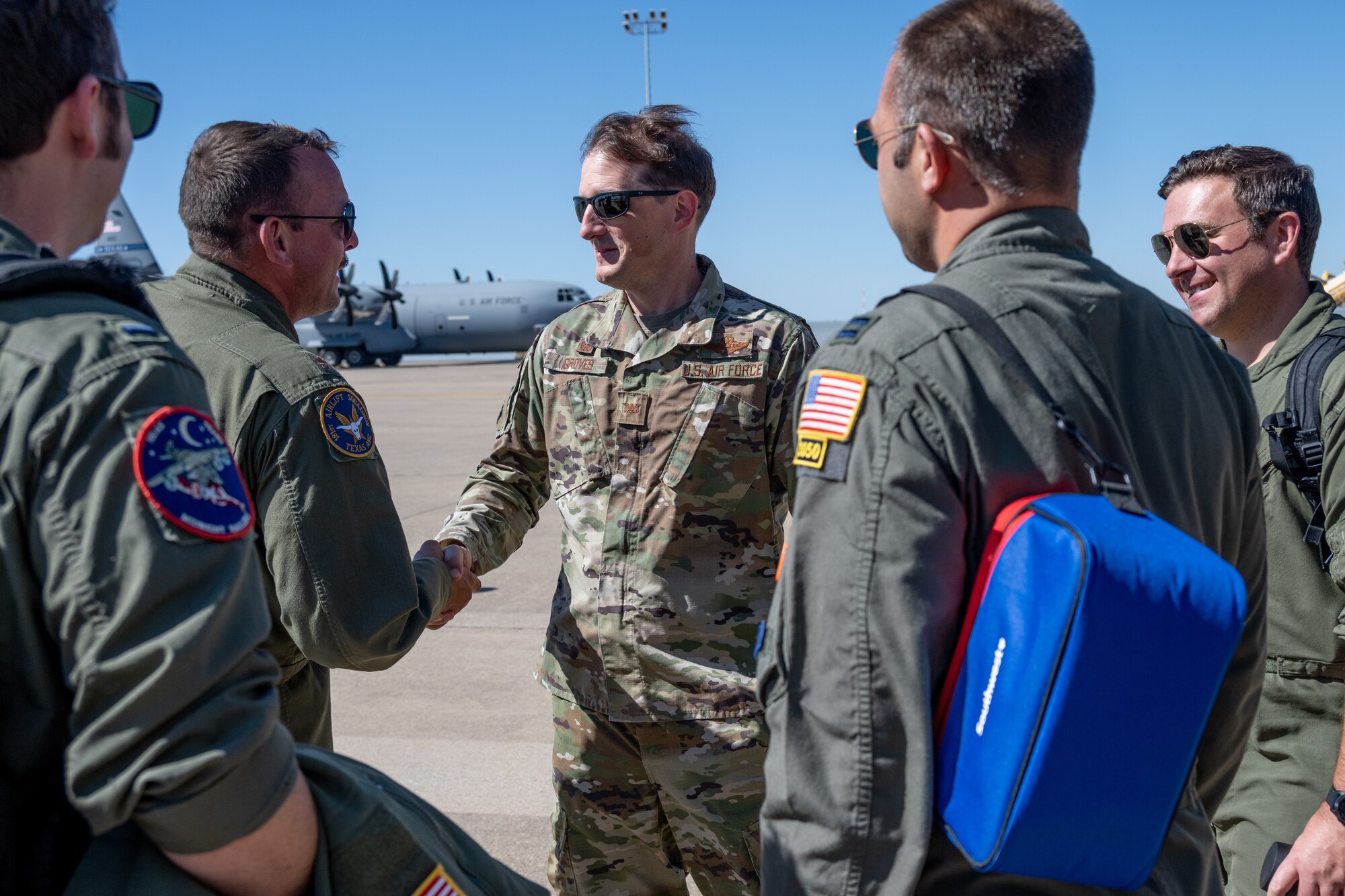 C-139J air crew shakes hands with wing commander on flightline.
