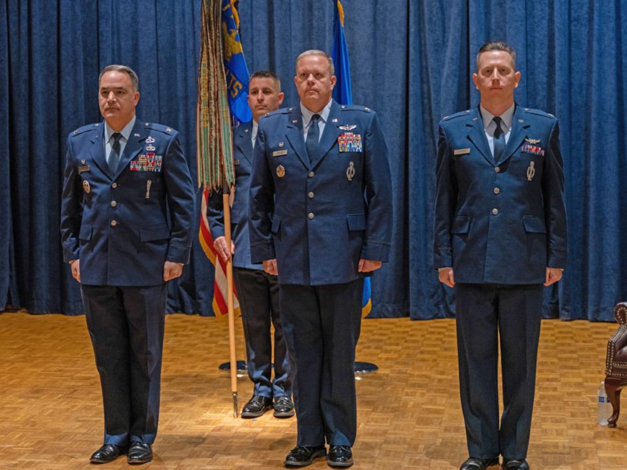 Officers stand at attention for change of command ceremony