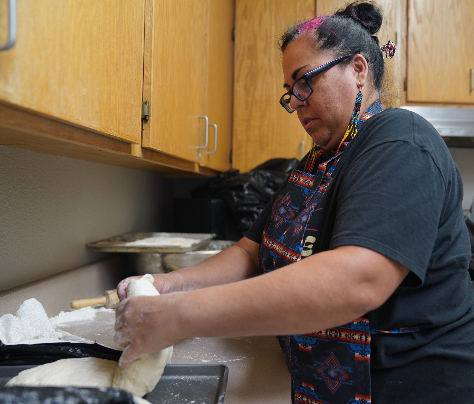 Desiree Pemberton forms dough to make Native American fry bread Nov. 8, 2022, at Beale Air Force Base, Calif.