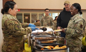 Master Sgt. Yvette Cabadas, 9th Reconnaissance Wing Diversity and Inclusion program manager, serves guests Native American tacos Nov. 8, 2022, at Beale Air Force Base, Calif.