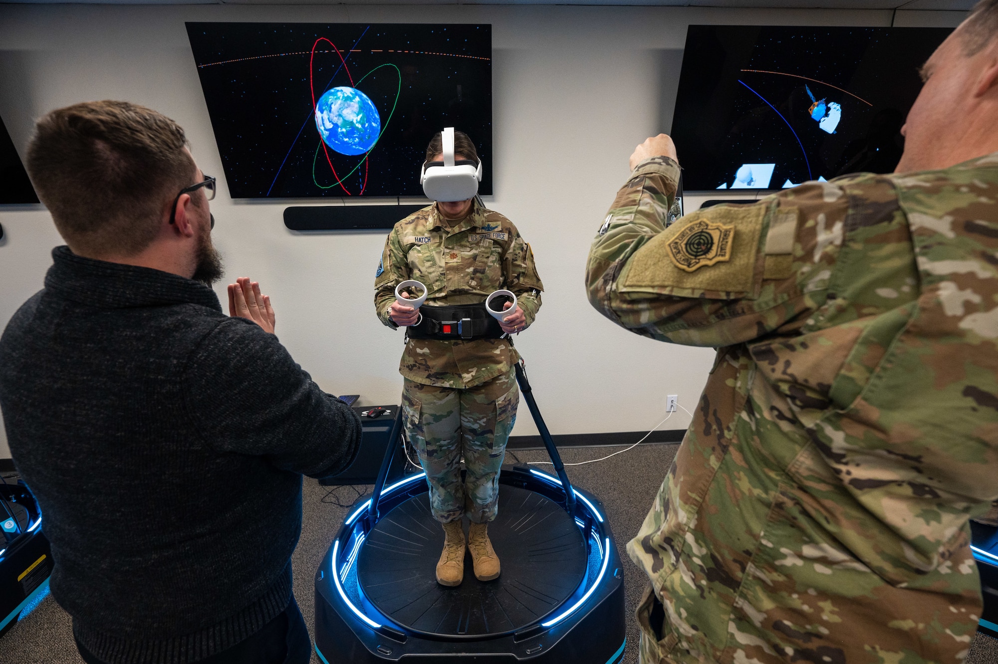 Maj. Chelsea Hatch, Aide de Camp, Space Training and Readiness Command, center, participates in a hands-on demonstration of a virtual reality immersion set inside the 'Innovation Lab' at the National Security Space Institute - West campus, Colorado Springs, Colo., Nov. 8, 2022.
