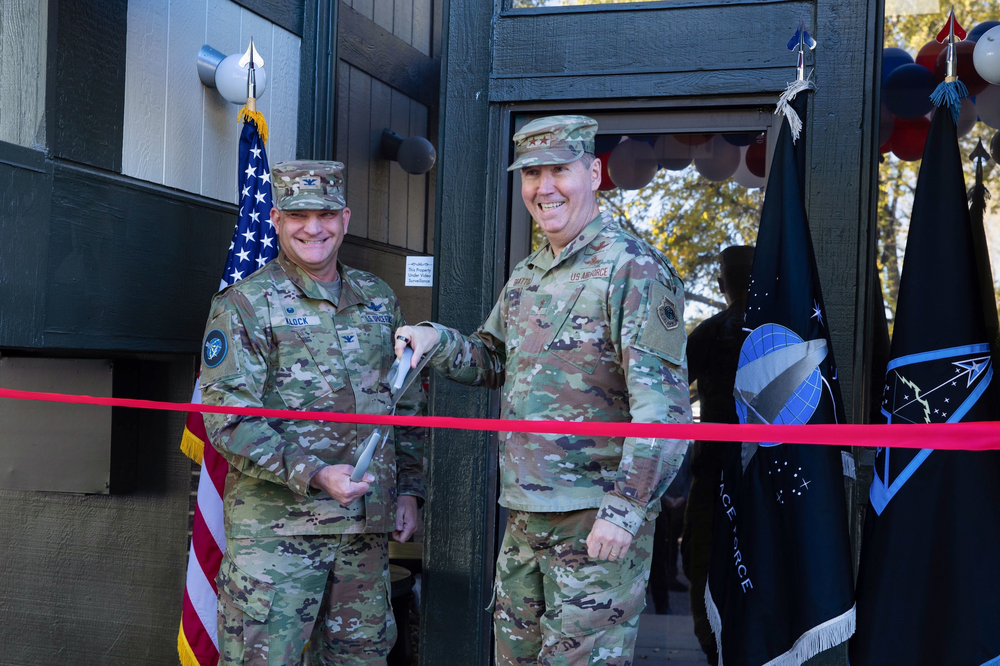 Maj. Gen. Shawn Bratton, Commander of Space Training and Readiness Command, right, and Col. Kenneth Klock, National Security Space Institute commandant, Delta 13, left, cut the ceremonial ribbon to mark the formal opening of the NSSI-West campus in Colorado Springs, Colo., Nov. 8, 2022.