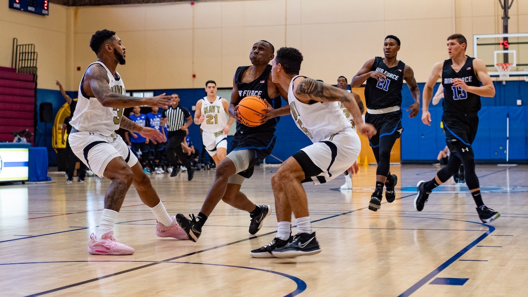 U.S. Air Force Capt. Clinton Siples, a member of team Air Force, drives to the basket at the 2022 Armed Force's Men's and Women's basketball championships held at the Admiral Prout Fieldhouse on Naval Base San Diego, California Nov. 6, 2022. Service members from the U.S. Army, Marine Corps, Navy (with Coast Guard players) and Air Force (with Space Force players) battle it out for the gold. (U.S. Air Force photo by Staff Sergeant James R. Crow)