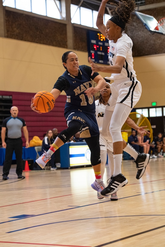 U.S. Navy Petty Officer 1st Class Christie Ayers, a member of team Navy, passes the ball during a game at the 2022 Armed Force's Men's and Women's basketball championships held at the Admiral Prout Fieldhouse on Naval Base San Diego, California Nov. 7, 2022. Service members from the U.S. Army, Marine Corps, Navy (with Coast Guard players) and Air Force (with Space Force players) battle it out for the gold. (U.S. Air Force photo by Staff Sergeant James R. Crow)