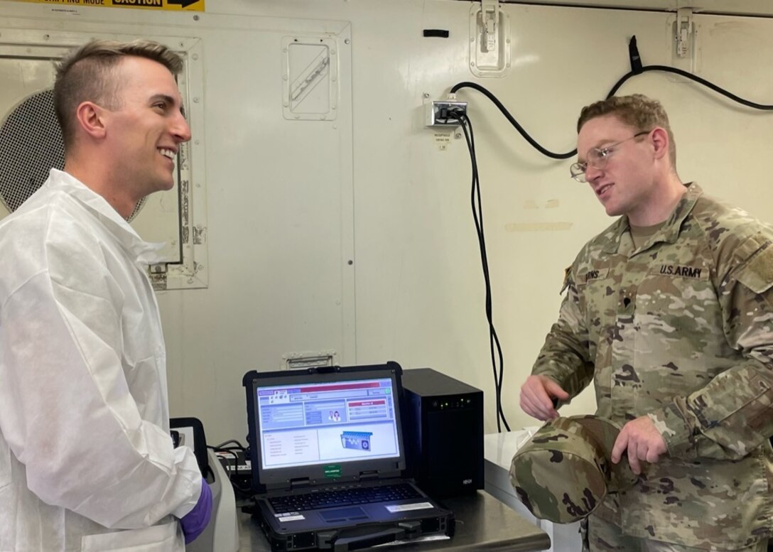 Soldier talks with talks inside a lab.