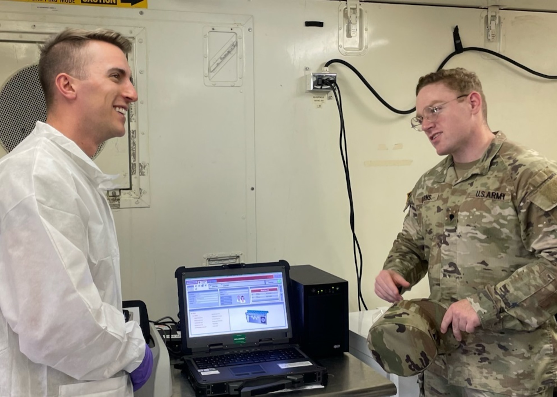 Soldier talks with talks inside a lab.