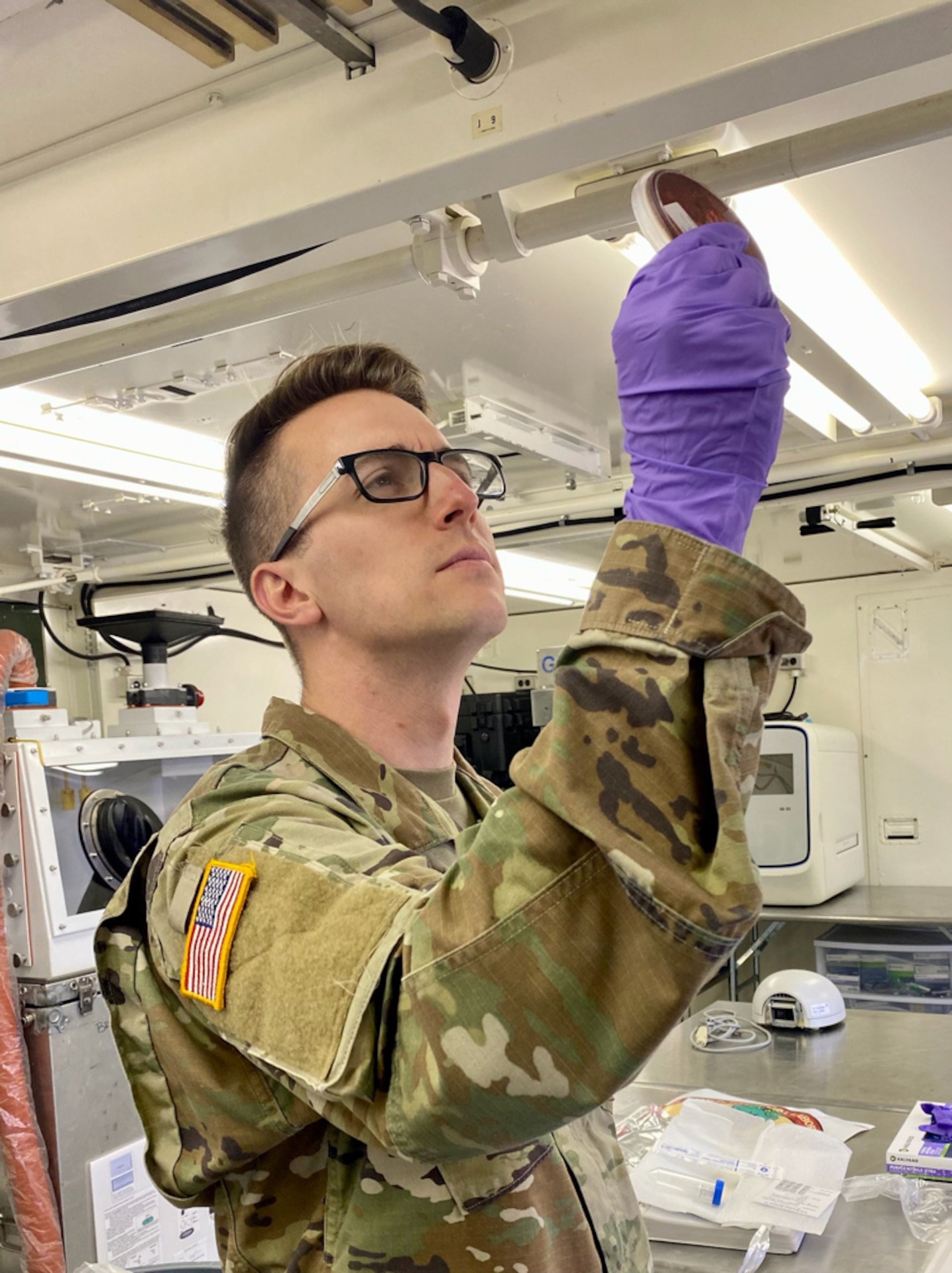 Soldier observes a specimen.
