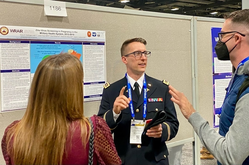 Soldier talks with visitors during a presentation.