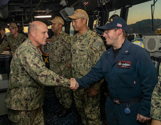 YOKOSUKA, Japan (Nov. 7, 2022) Chief of Naval Operations (CNO) Adm. Mike Gilday congratulates Boatswain’s Mate 2nd Class Benjamin Stier, from San Antonio, on his reenlistment during his visit to Arleigh Burke-class guided-missile destroyer USS Rafael Peralta (DDG 115), moored at Commander, Fleet Activities Yokosuka, Nov. 7. Rafael Peralta is assigned to Commander, Task Force 71/Destroyer Squadron (DESRON) 15, the Navy’s largest forward-deployed DESRON and the U.S. 7th Fleet’s principal surface force. (U.S. Navy photo by Mass Communication Specialist 1st Class Deanna C. Gonzales)