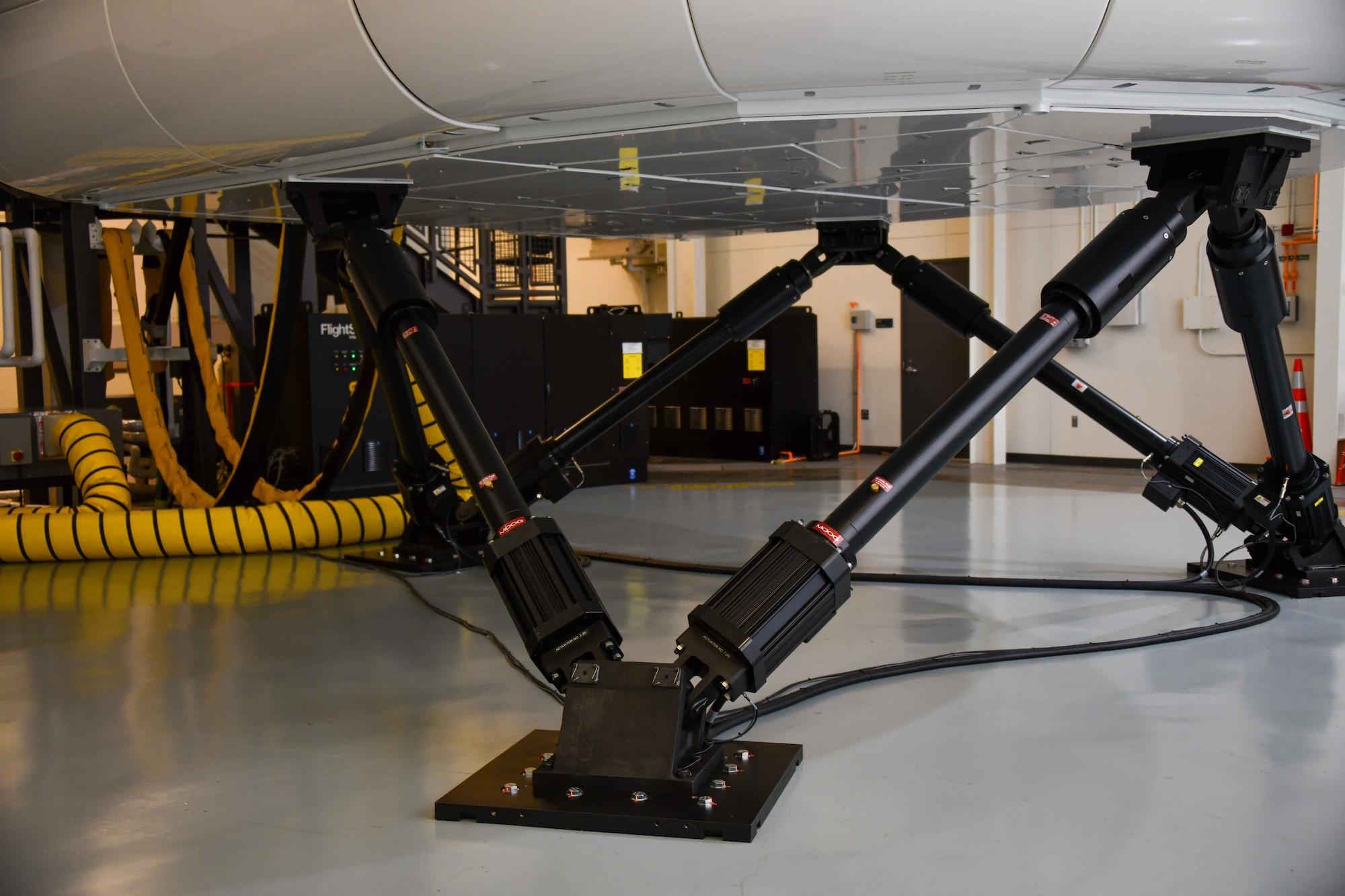 The hydraulic system under the KC-46 Pegasus boom operator simulators in the schoolhouse at Altus Air Force Base, Oklahoma, November 3, 2022. The hydraulic system is very unique to these simulators, creating motion that is essentially identical to flying on the real thing for aircrew and pilots. (U.S. Air Force photo by Airman 1st Class Kari Degraffenreed)